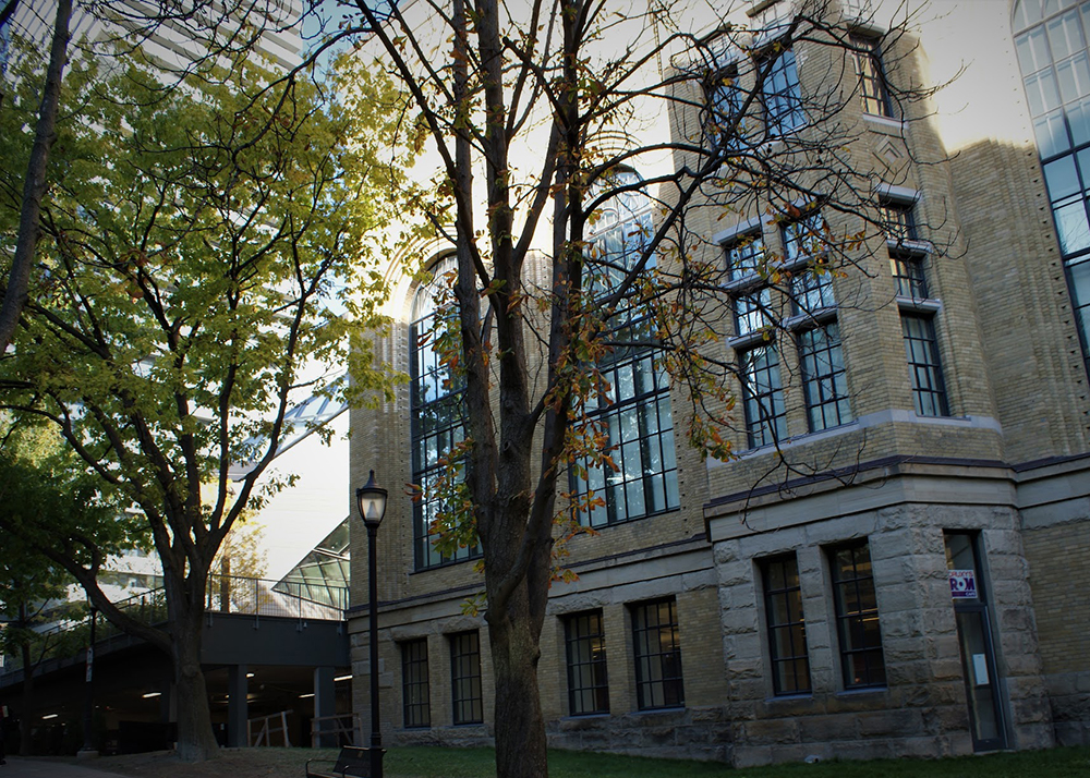 West side of Royal Ontario Museum with windows and trees in front.